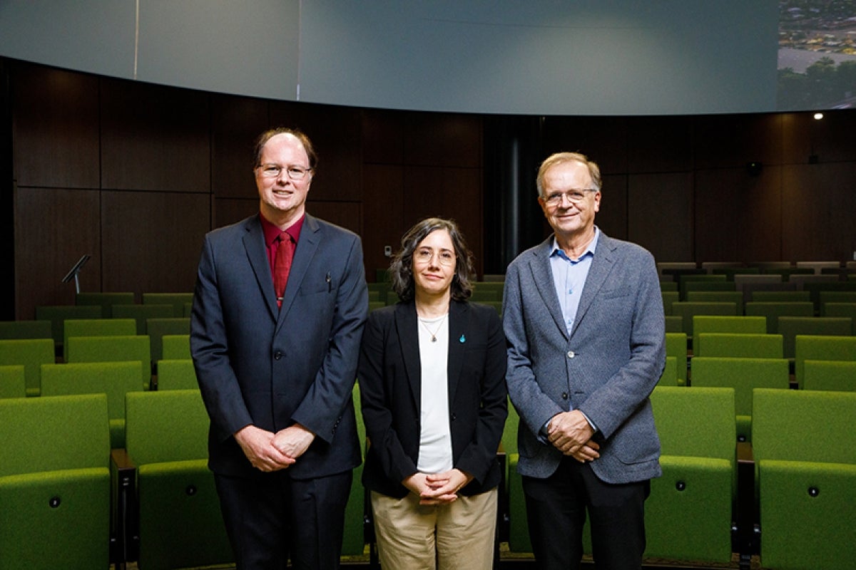 Three people in a theater. 