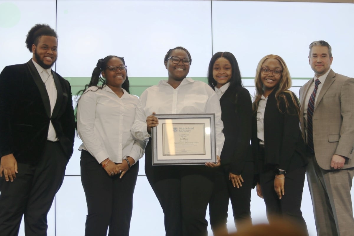 Students posing with a certificate