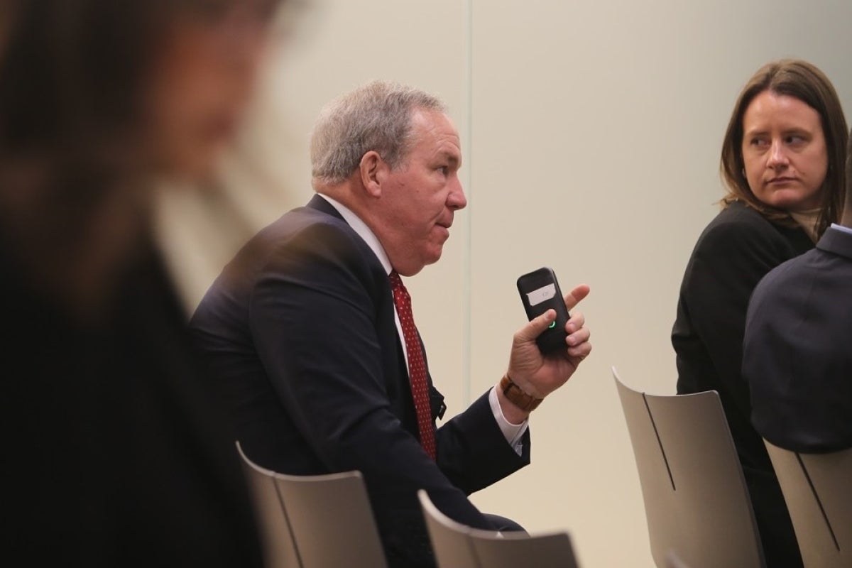 Benjamin C. Freakley sitting in the audience and speaking to unseen presenters