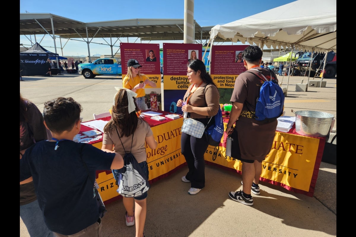 Luke Days visitors stop by ASU's Graduate College display during the first day of the air show before it was open to the general public, Friday, March 22. 