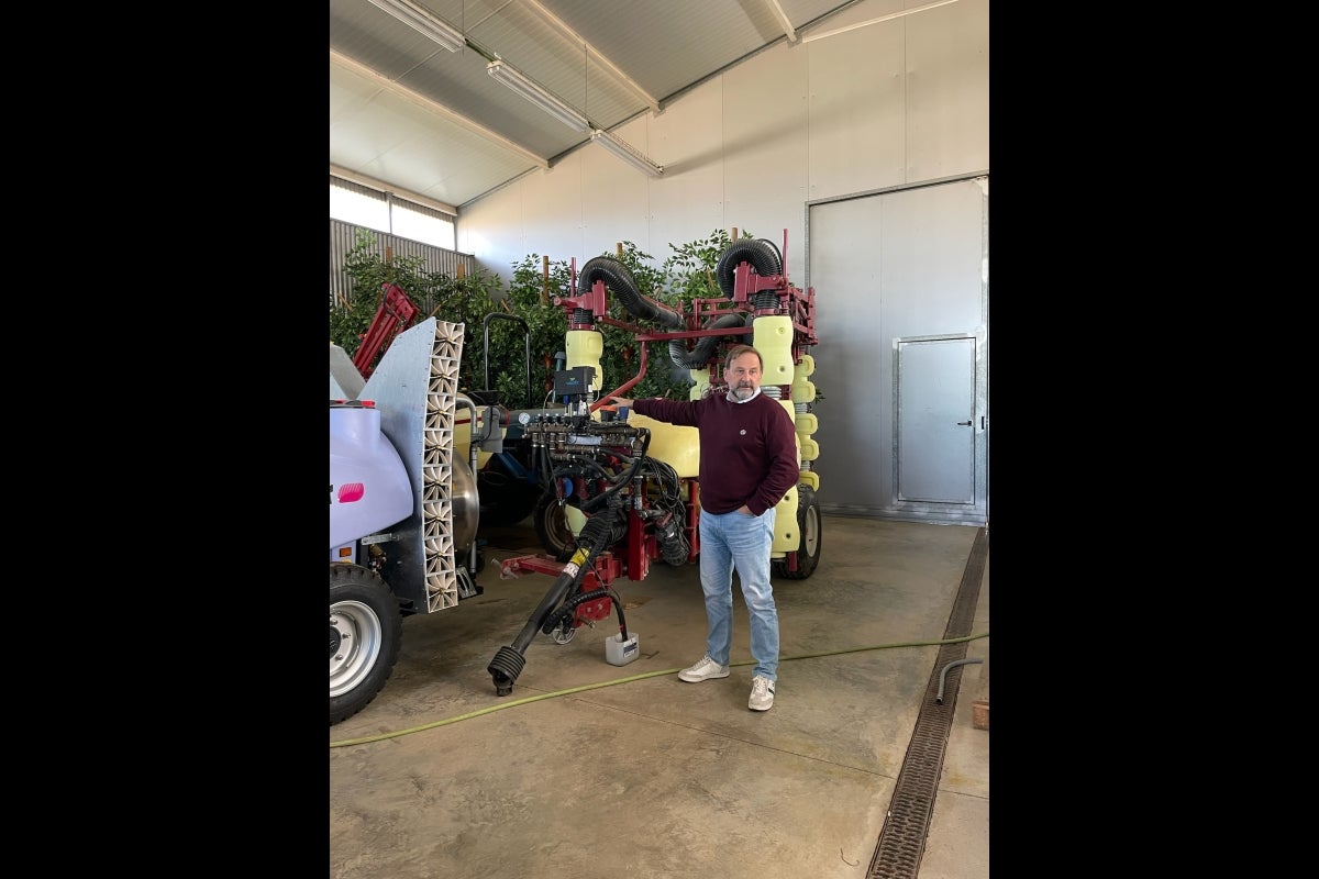 Professor Emilio Gil standing next to equipment