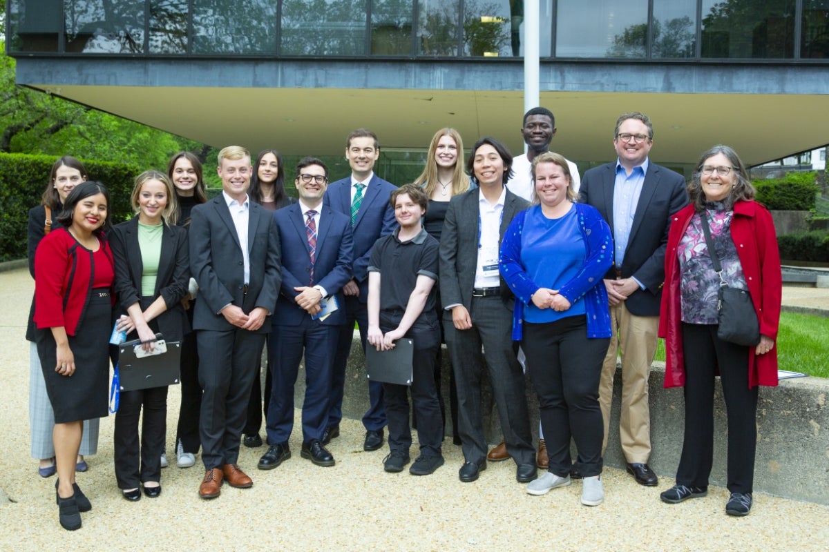 Students, professors and Brazilian diplomats stand in front of the Brazilian Embassy in Washington D.C.