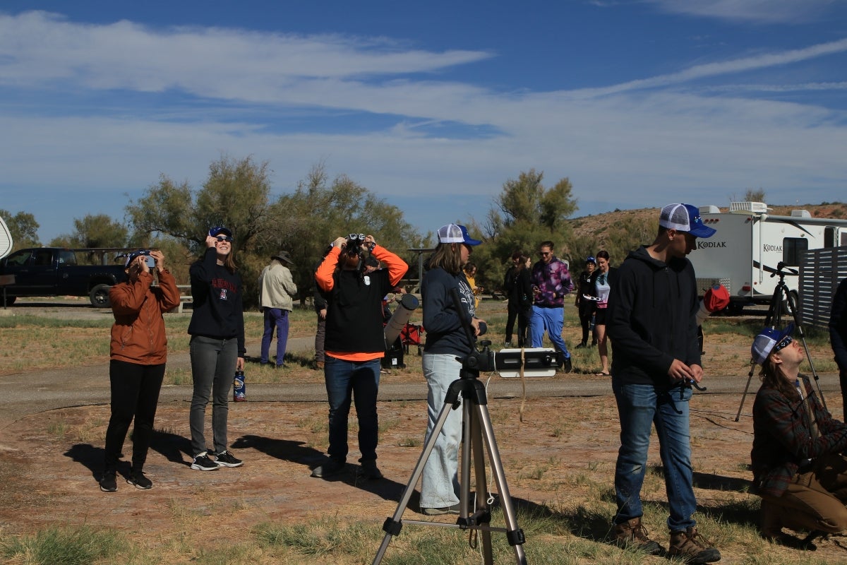 People looking up at an eclipse.