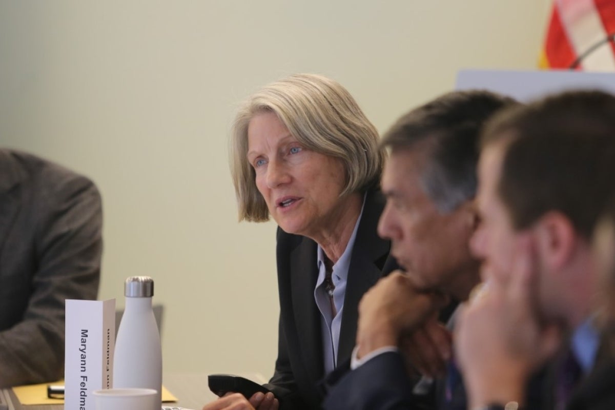 Maryann Feldman sits at a table with others