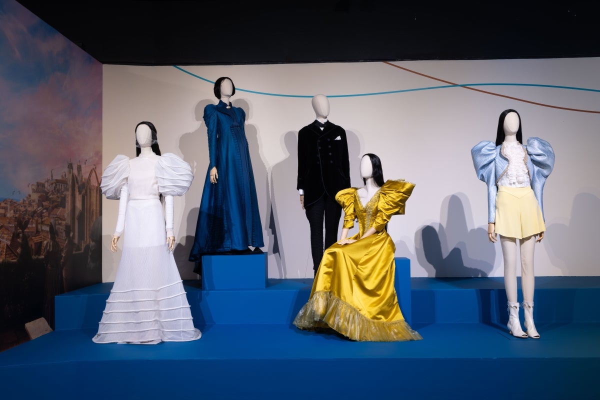 Costumes on display in a museum gallery.