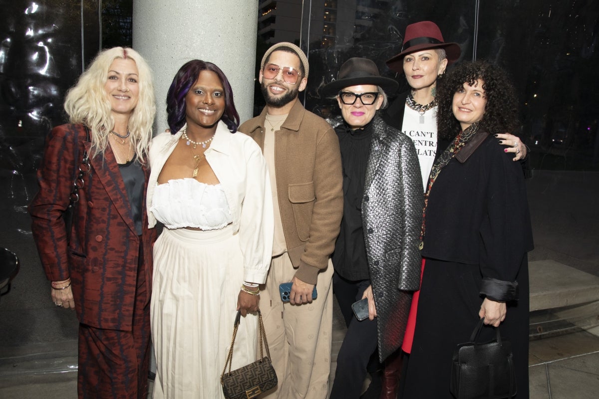 People posing for a group photo at a museum event.