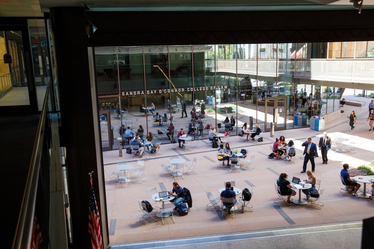 Students sitting on outdoor tables in courtyard in downtown Phoenix