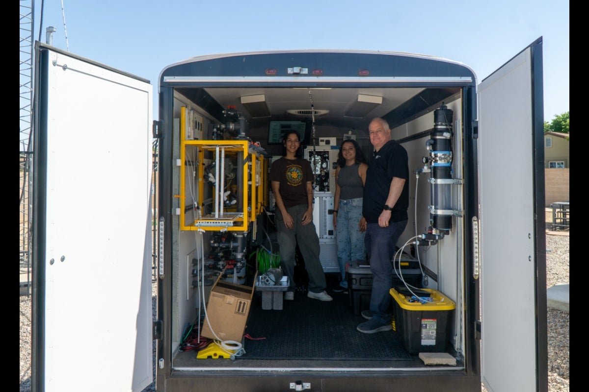 Three people inside a large van.