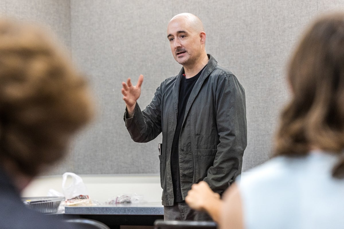 A man stands in front of a classroom