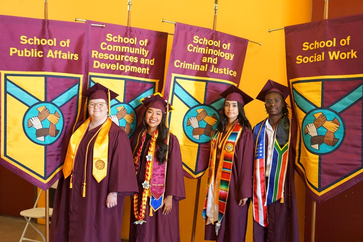 Four graduates hold gonfalons