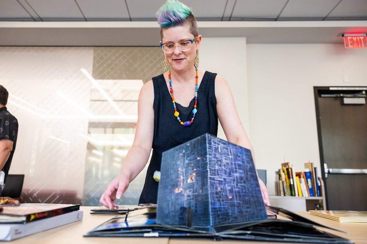 Woman presenting a pop-up book