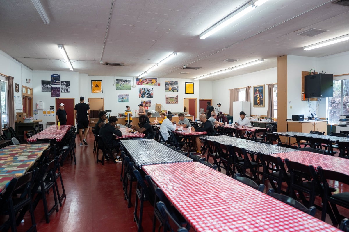 ASU football players eat it at long tables in a cafeteria