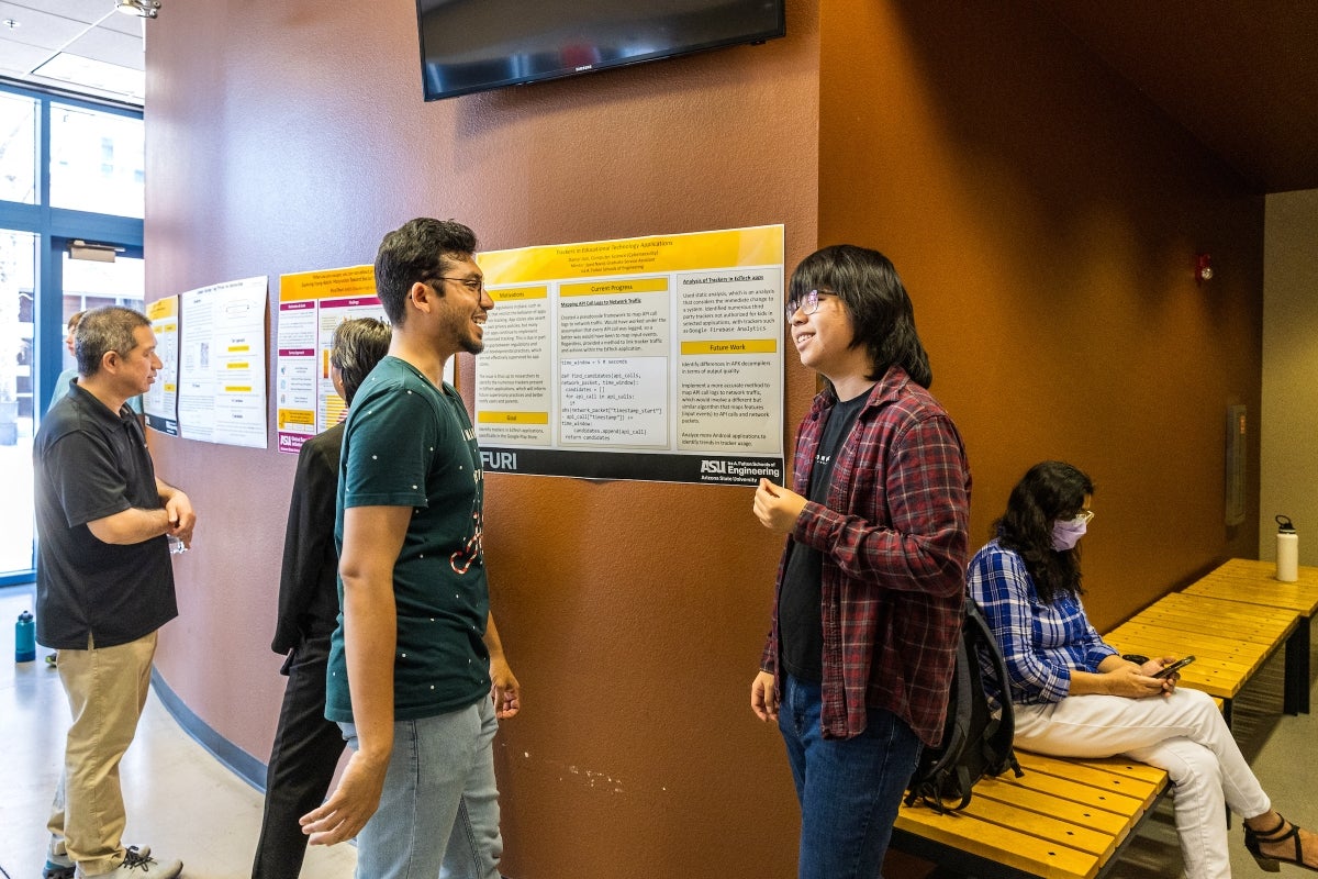 ASU mentor and Arizona high school student talk during poster session