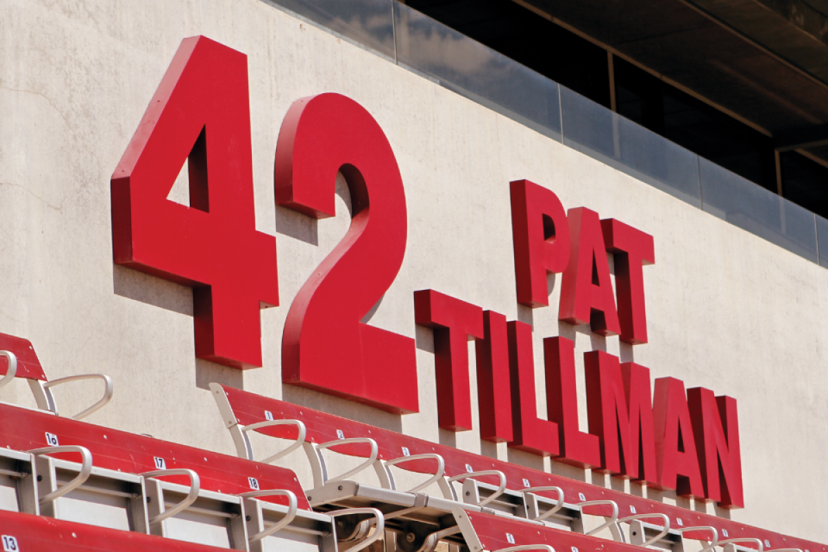 Large letters that say Pat Tillman 42 above bleachers in a stadium