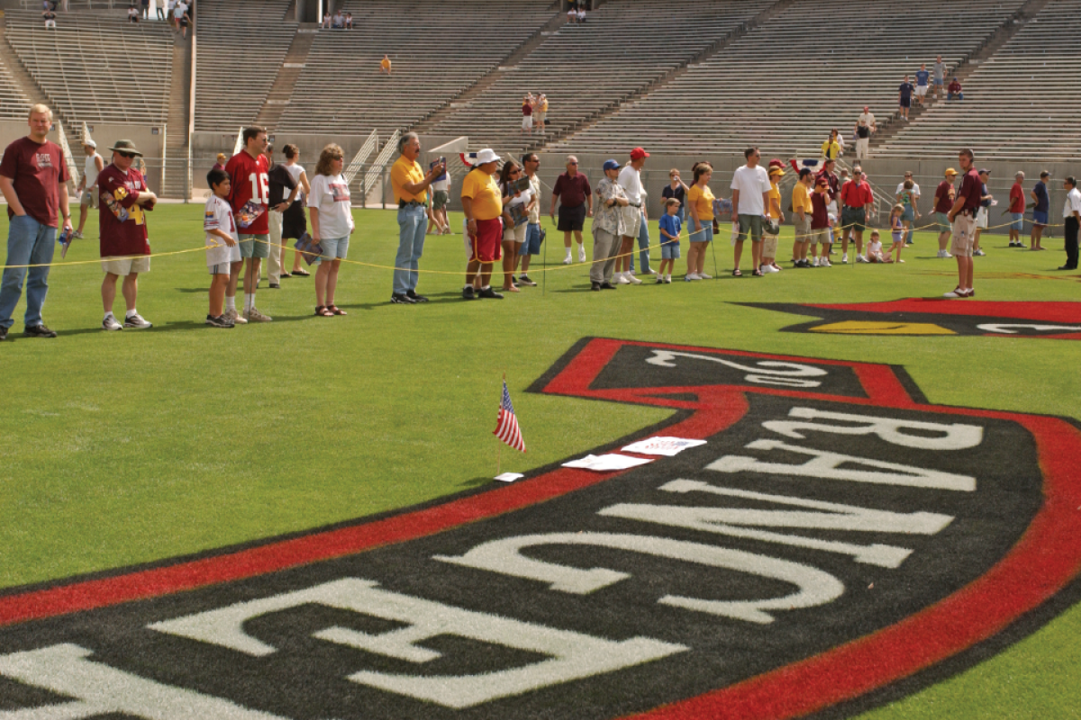 People on football field honoring Pat Tillman