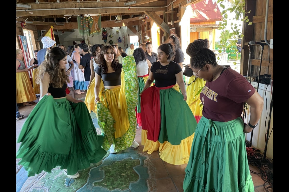 Group of students dancing with their bomba dresses Photo courtesy of Karen Gregory-Mercado