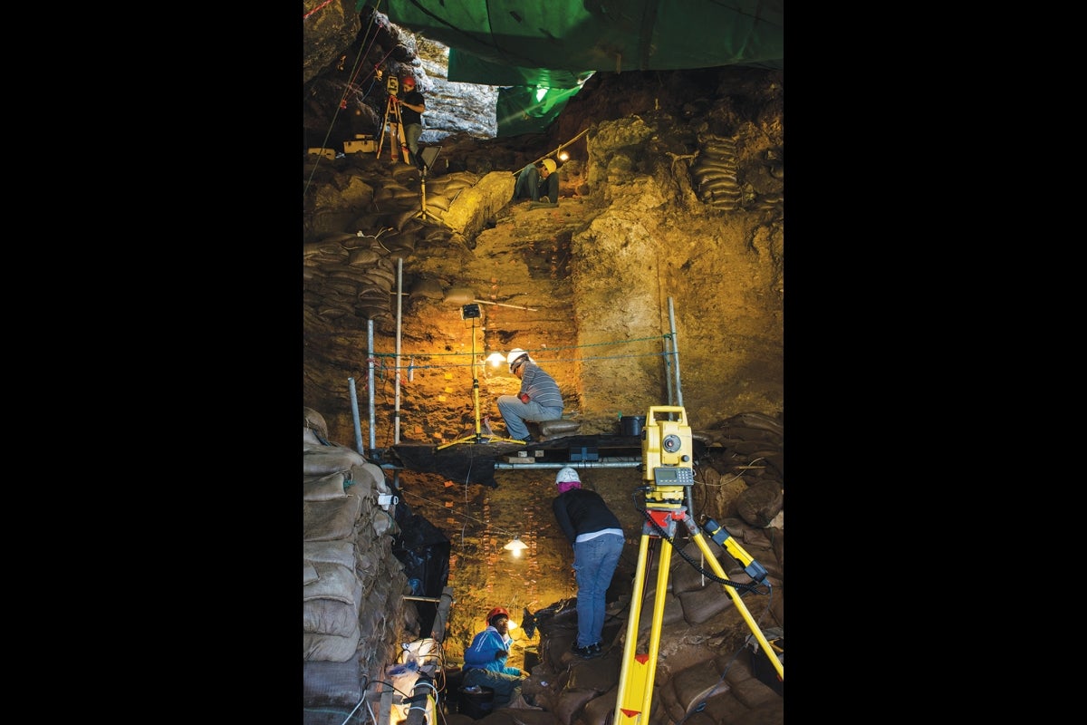 A person in gear working in a cave