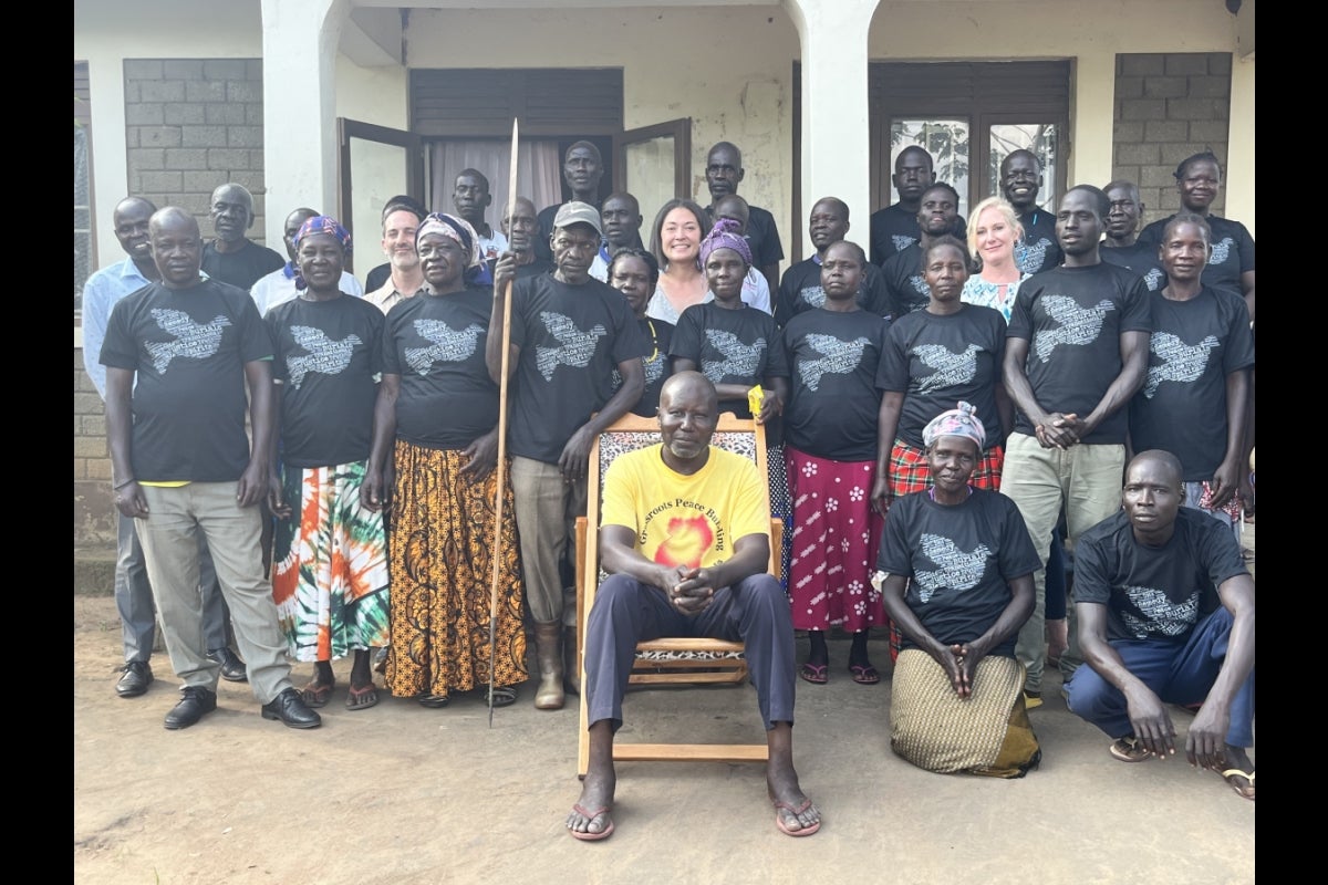 Members of the Pawel community in Uganda take a group photo with university researchers