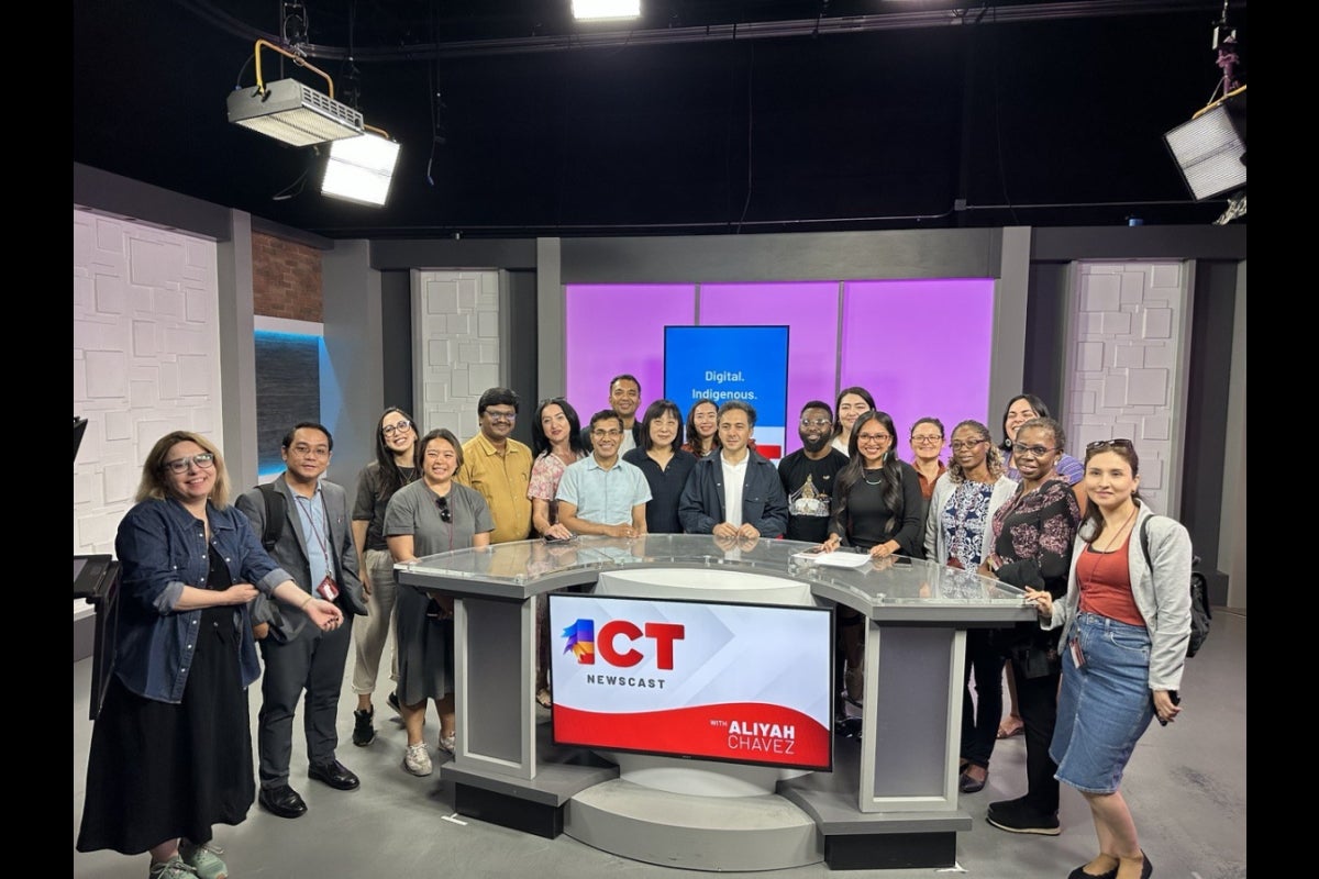 A group photo of SUSI Scholars on the set of the I C T Newscast