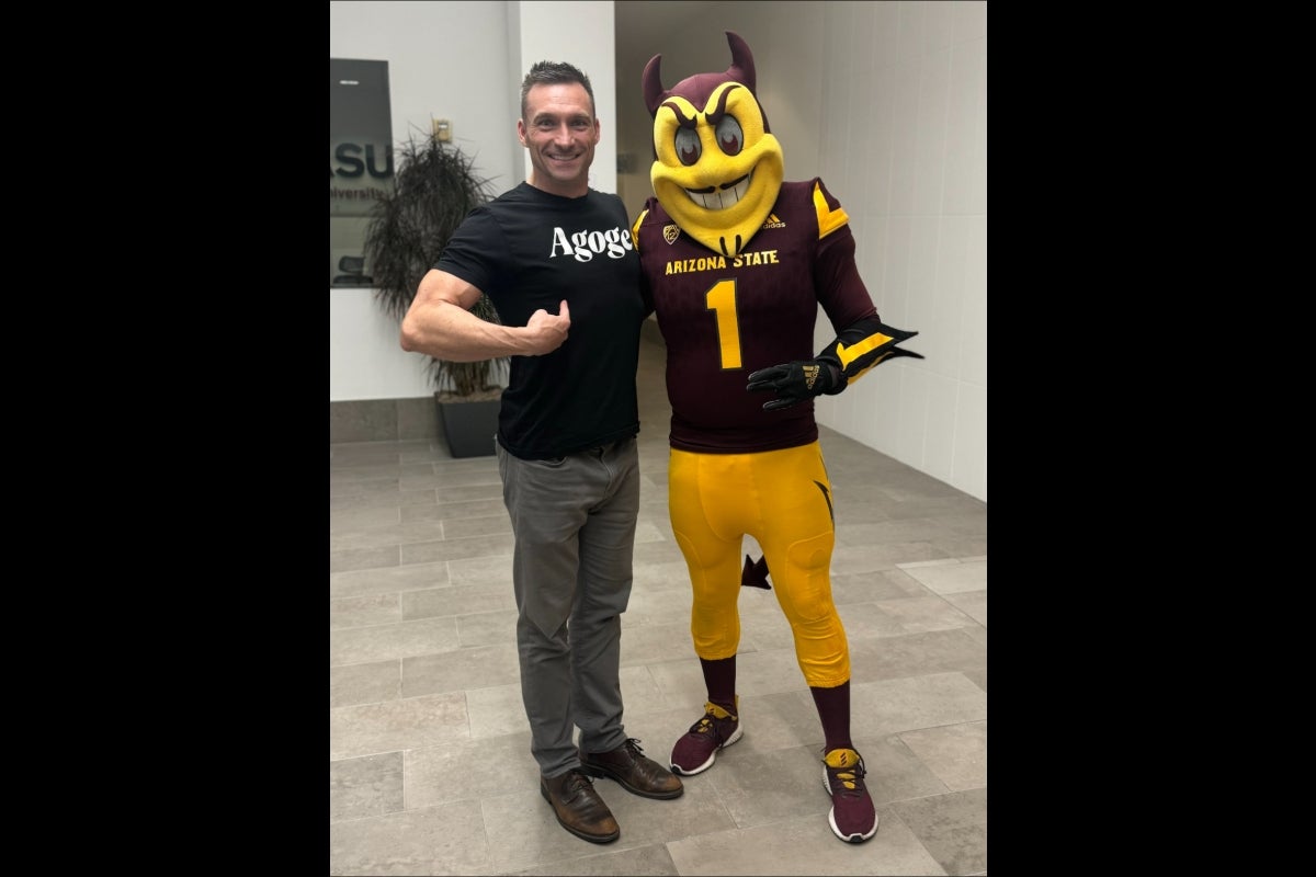 Man standing next to ASU mascot Sparky the Sun Devil.