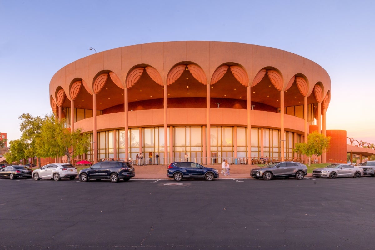 A round, pink building with arches