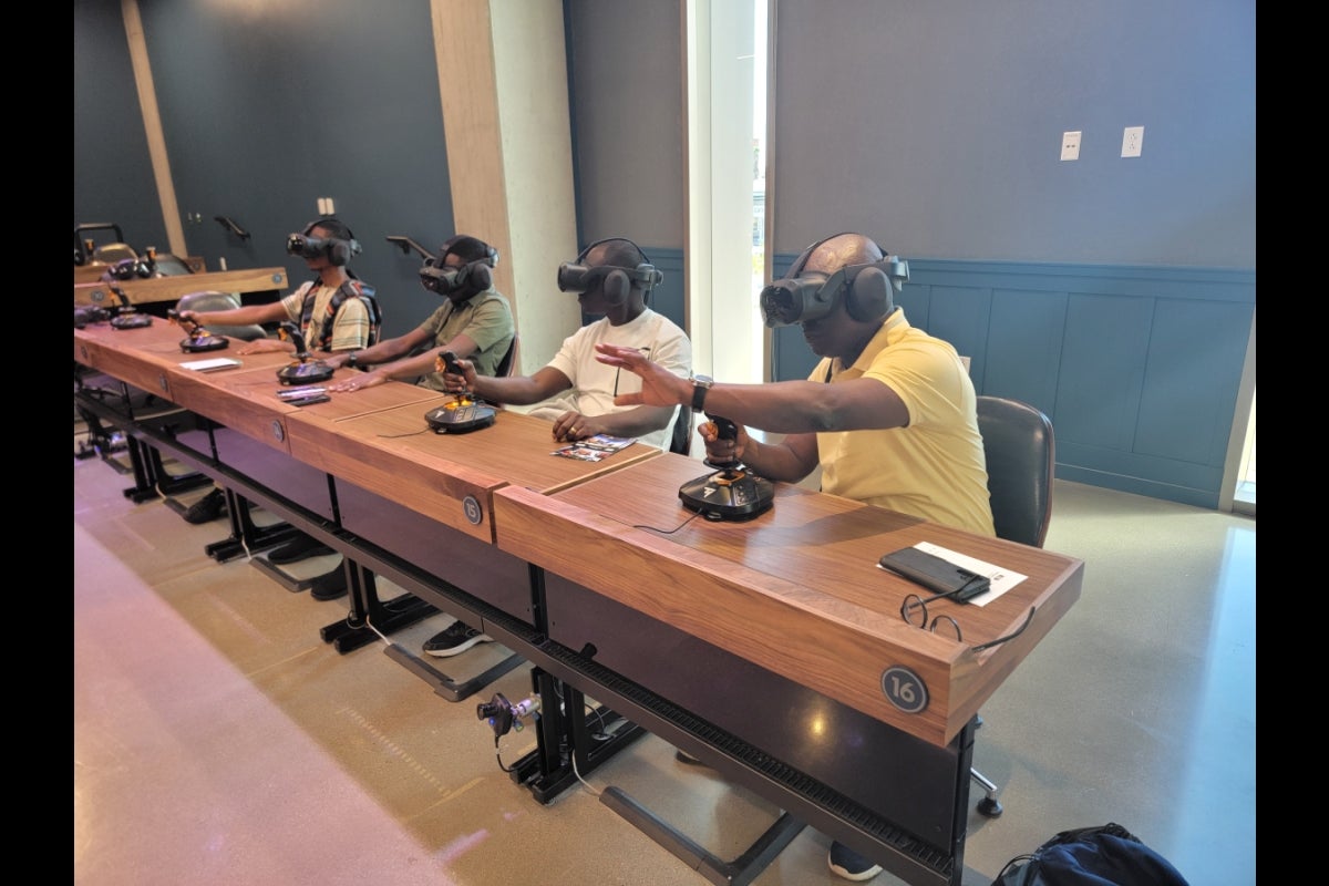 CARISCA team members seated at desks wearing VR headsets.