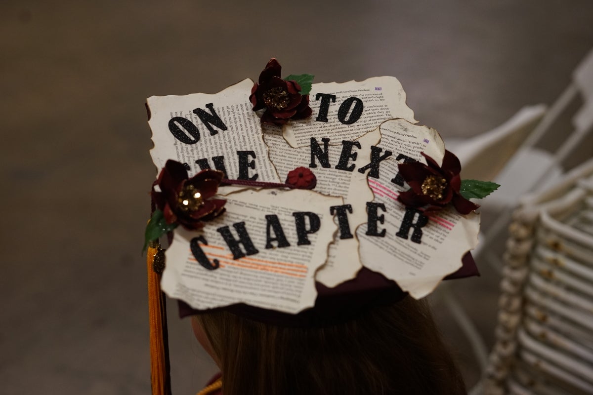 Graduation cap decorated with pages from a book.