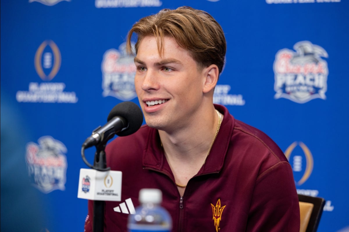 An ASU football player speaks into a mic on a table