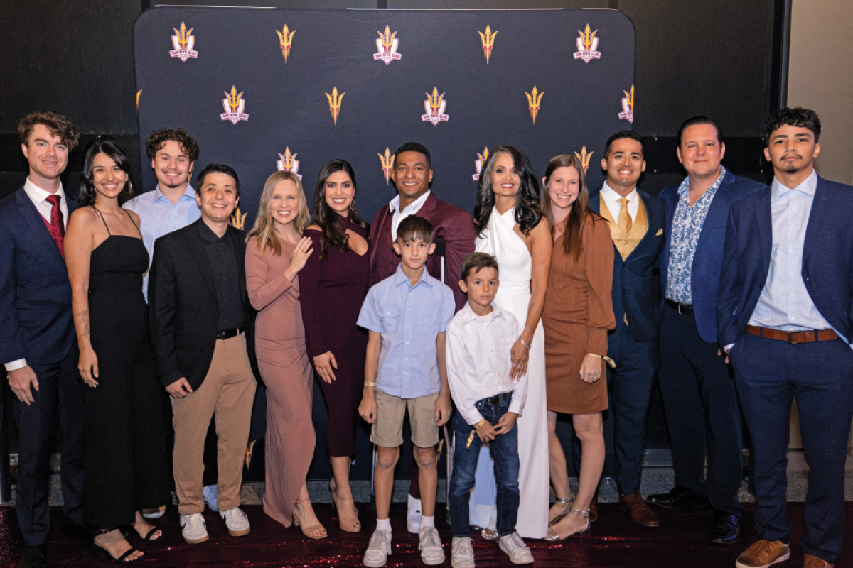 A large group family photo taken in front of an ASU backdrop during a film premiere