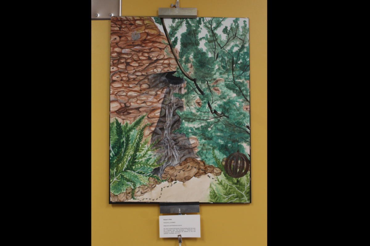 Artwork that depicts an outdoor setting hanging on a wall.