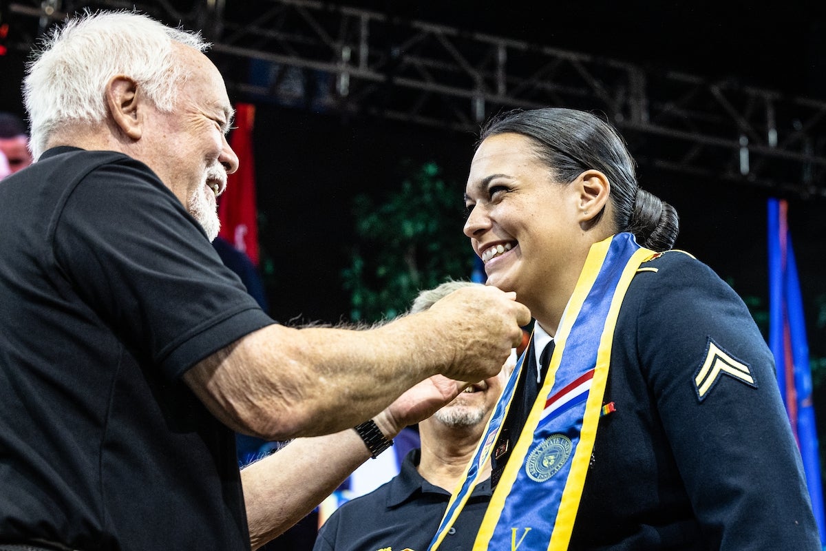 ASU Alumni Veterans Chapter past president David Lucier presents U.S. Army CPL Haley Espinoza with her honor stole