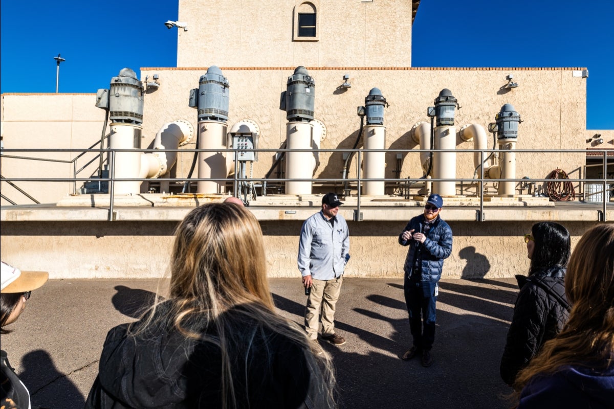 People gathered around a water facility