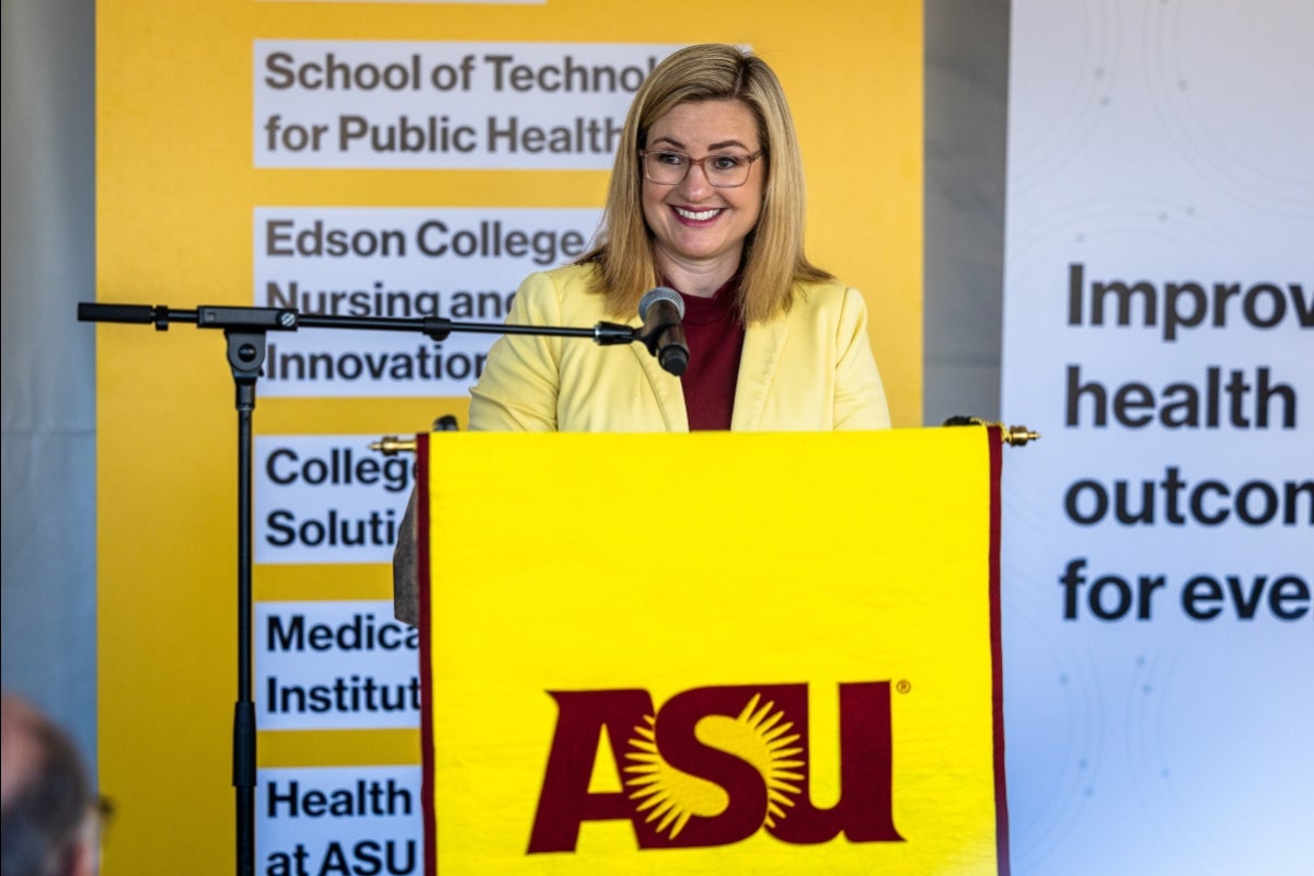 Phoenix Mayor Kate Gallego speaks at a lectern in front of ASU Health signs