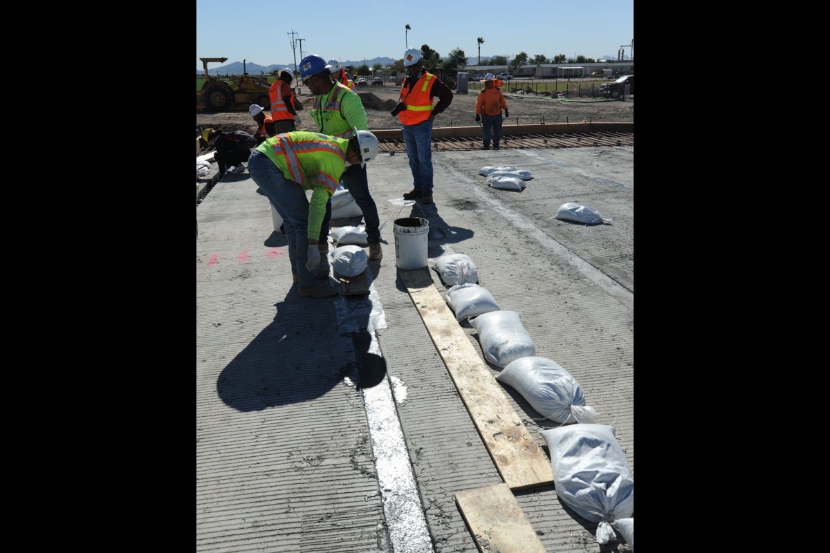 Workers apply UHPC to bridge slab connections on Buckeye's Palo Verde Bridge.