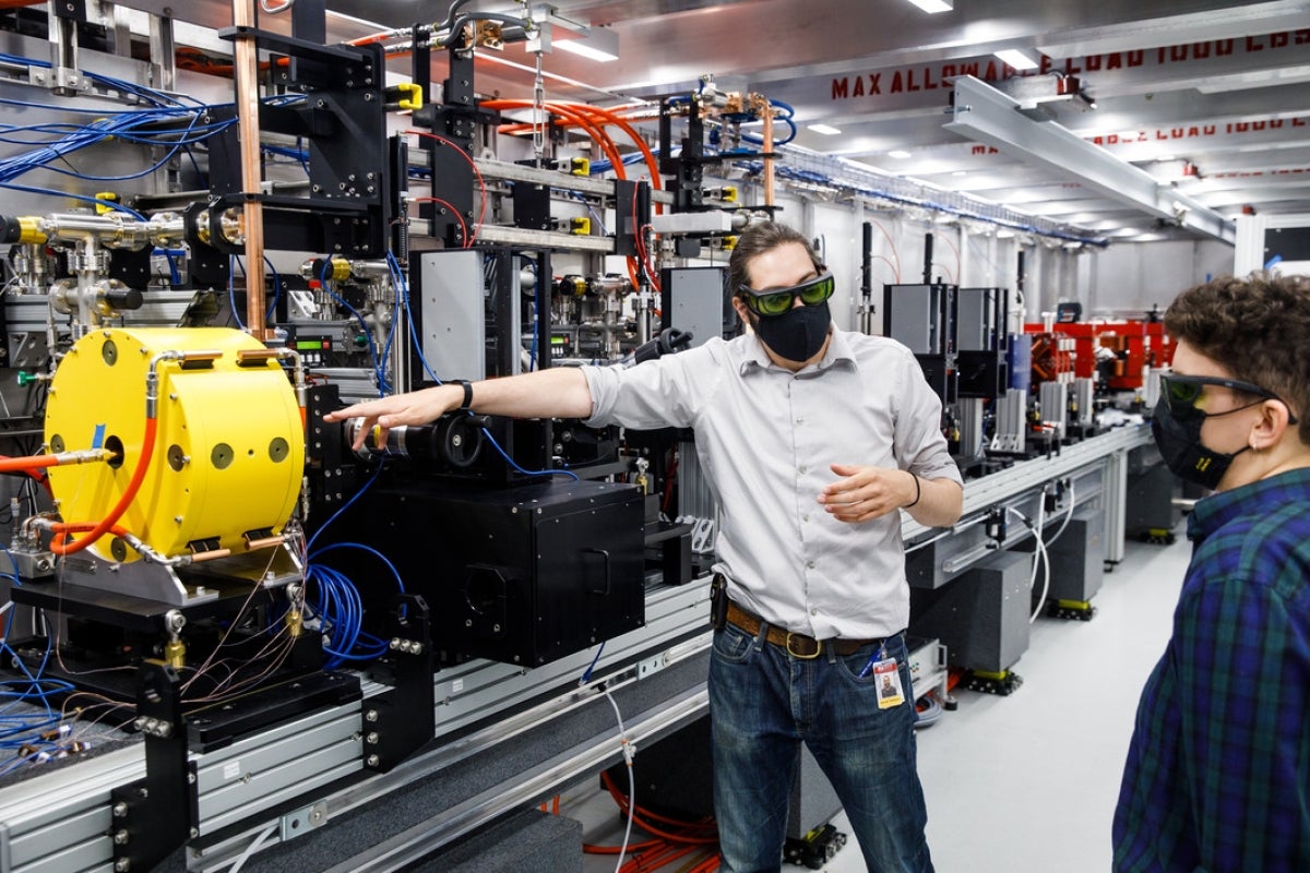 Assistant Professor Samuel Teitelbaum stands by a newly commissioned prototype instrument called the Compact X-ray Light Source.