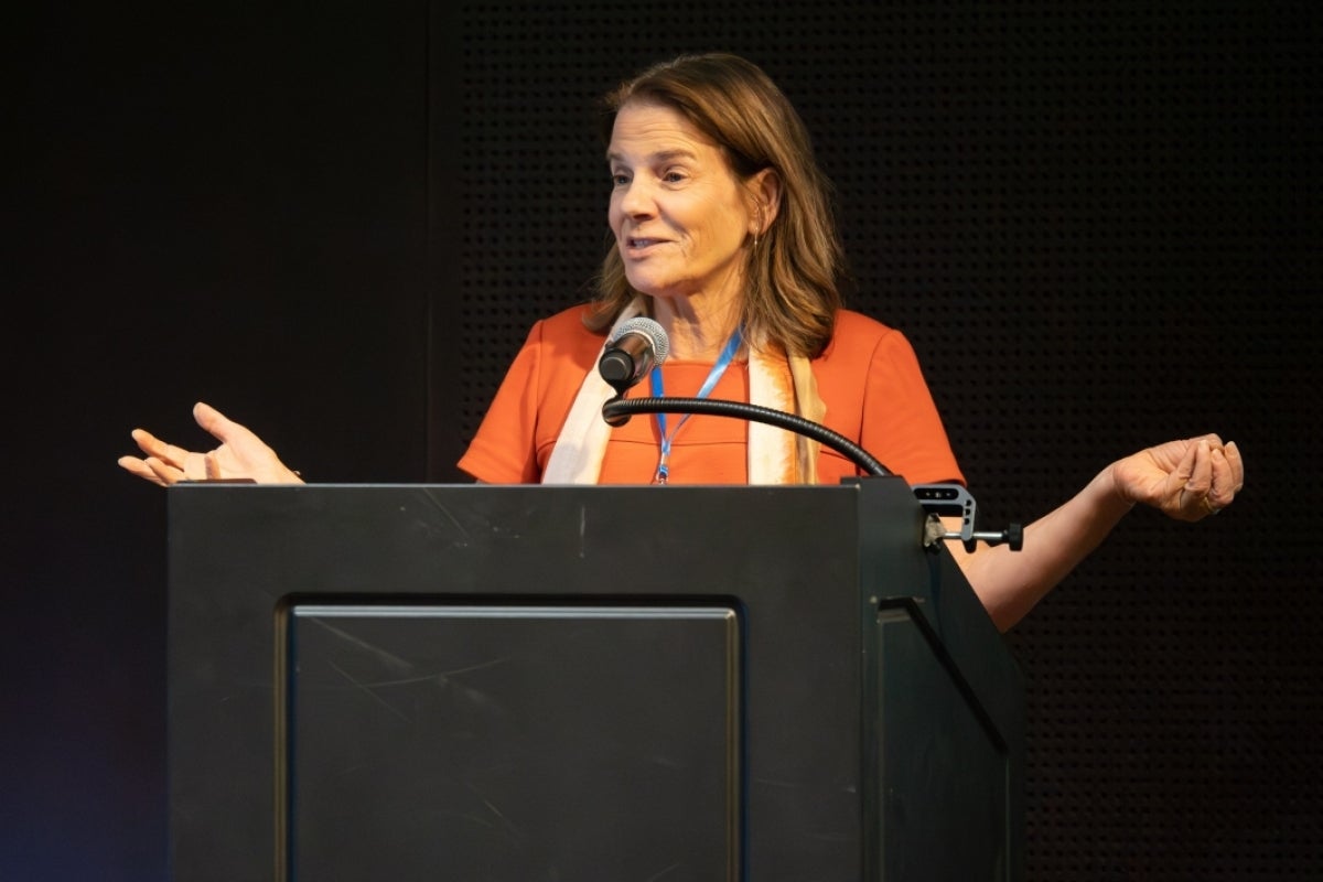 Dr. Kristine Yaffe stands at a podium delivering a keynote speech.