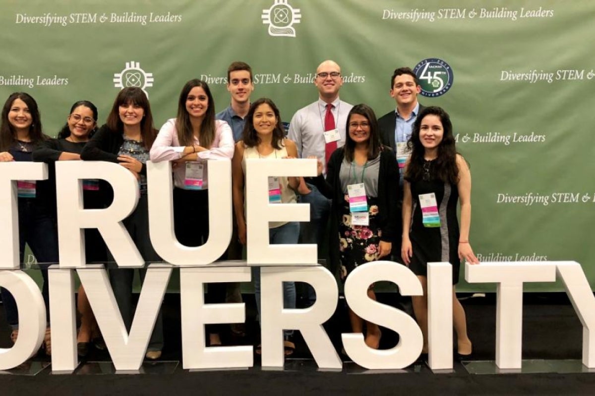 group photo in front of a sign reading 