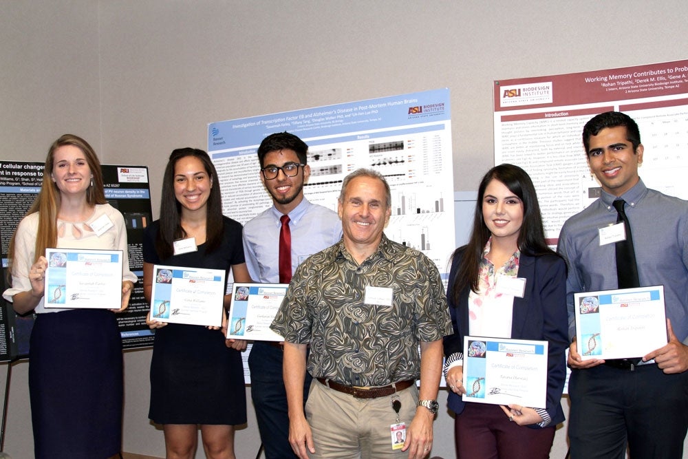 group of people holding certificates