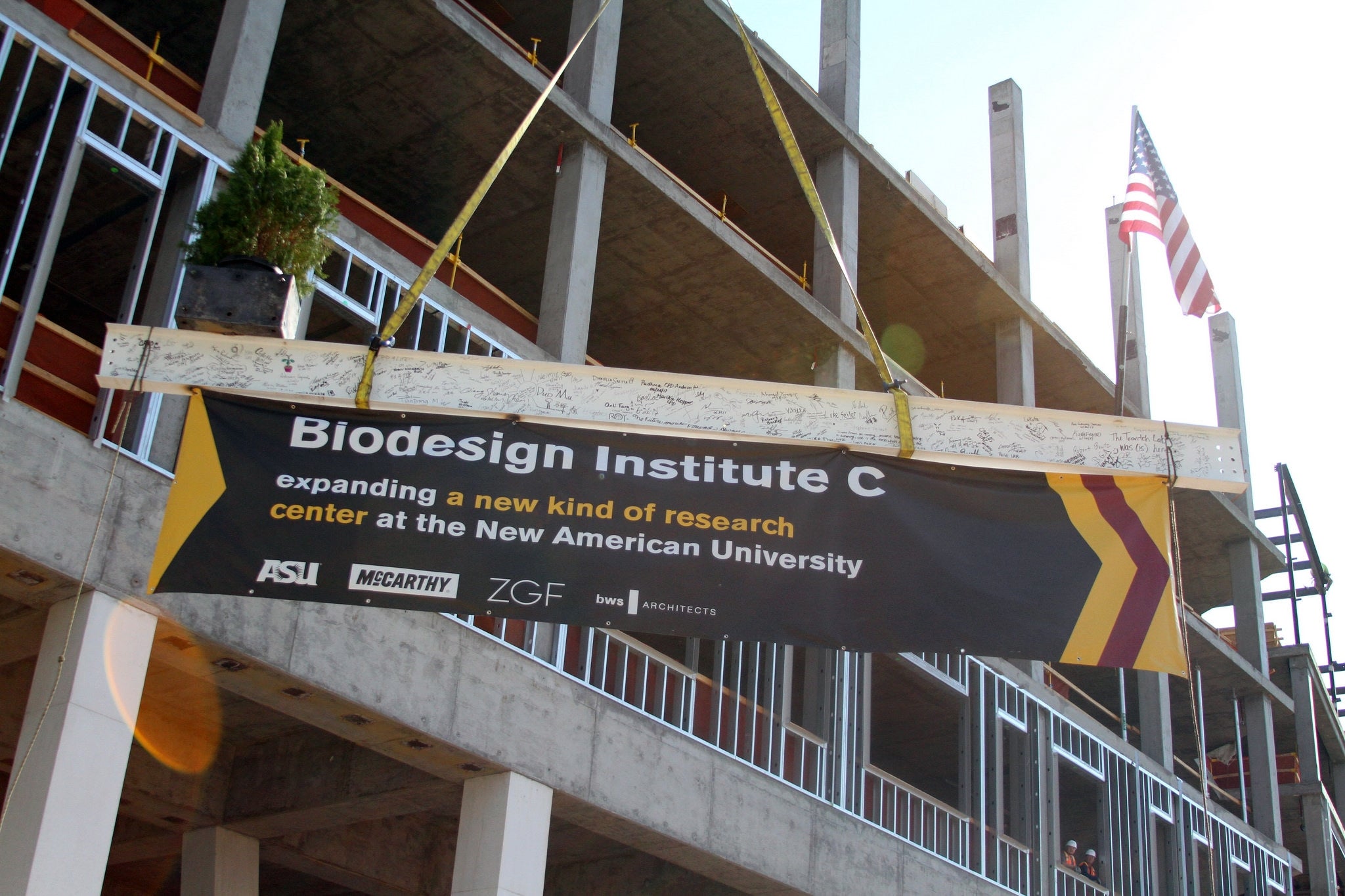 The final beam is hoisted to the top of Biodesign C