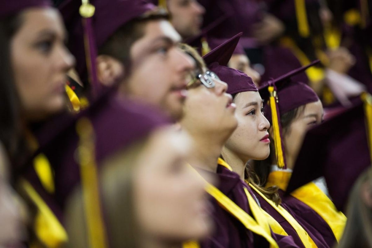 students listening to speaker at graduation