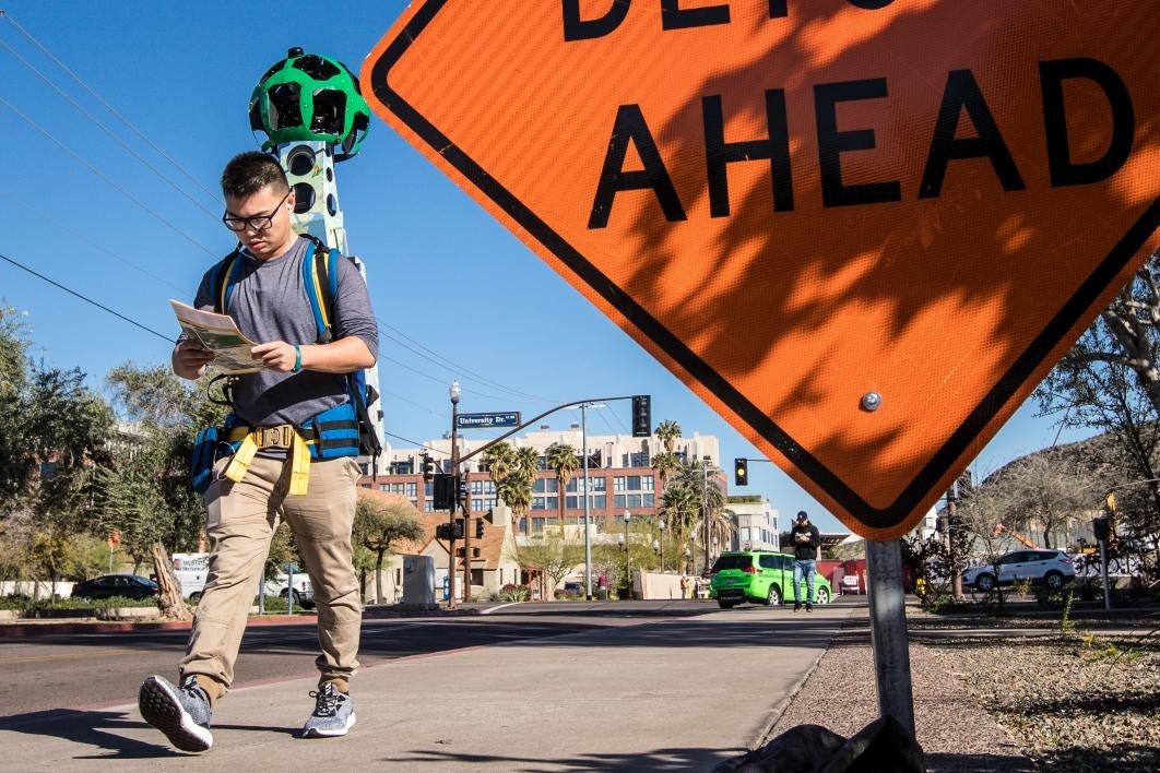 Walking by the detour sign