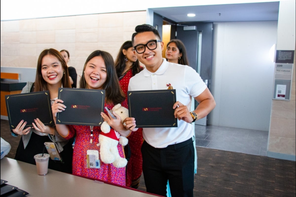 Students from the University of Economics and Finance receive their certificates at the ASU-Cintana Summer Program Closing Ceremony