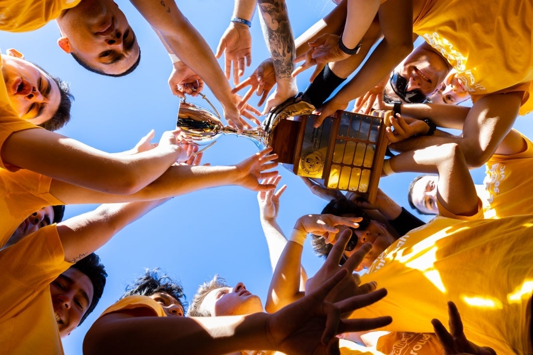 Students cheer after winning the Dean's Cup flag football tournament.