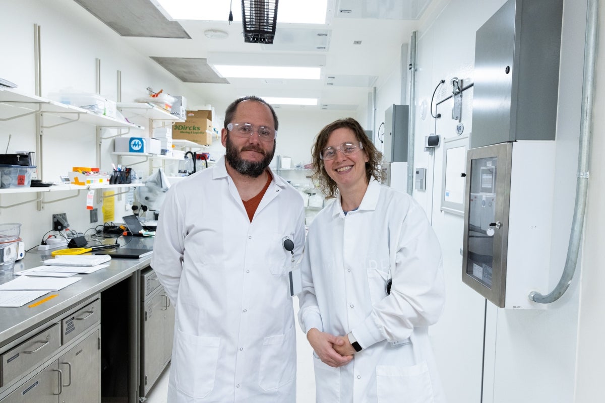 Experts Huijben and Paaijmans stand inside the new laboratory.