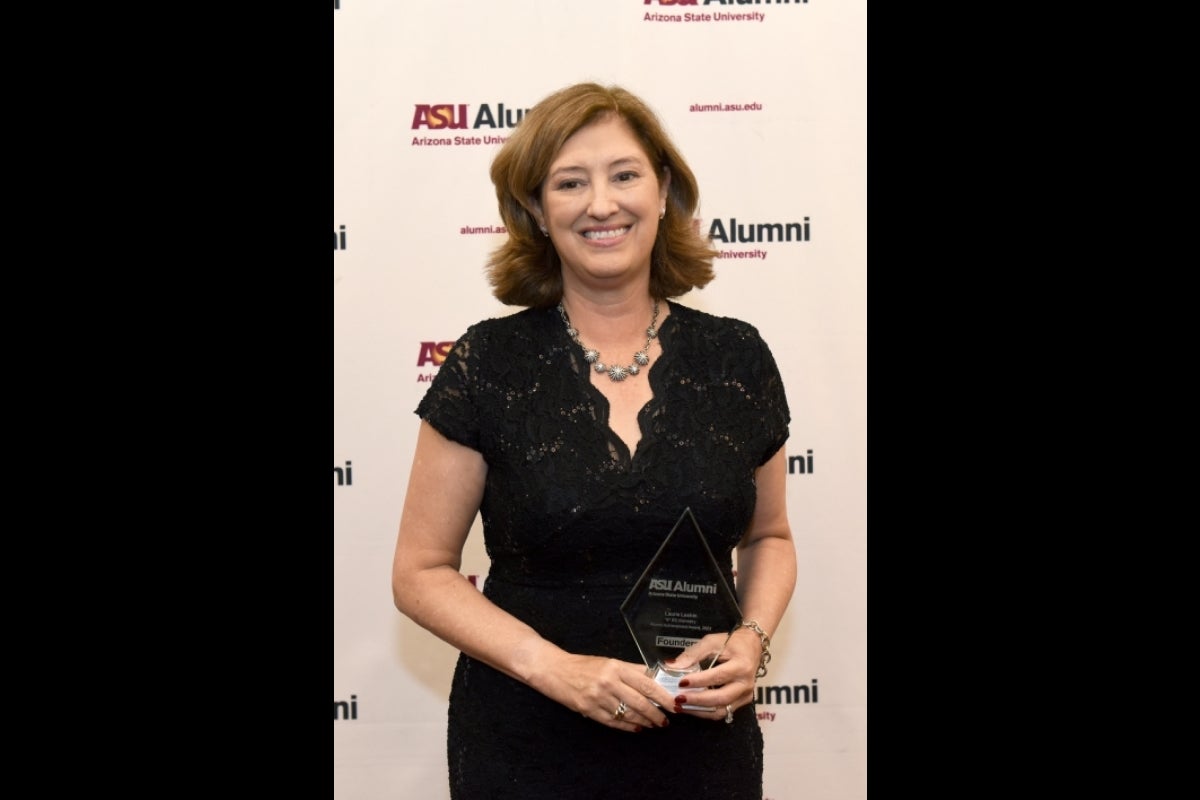 Woman holding an award at ASU Founders' Day 2023.