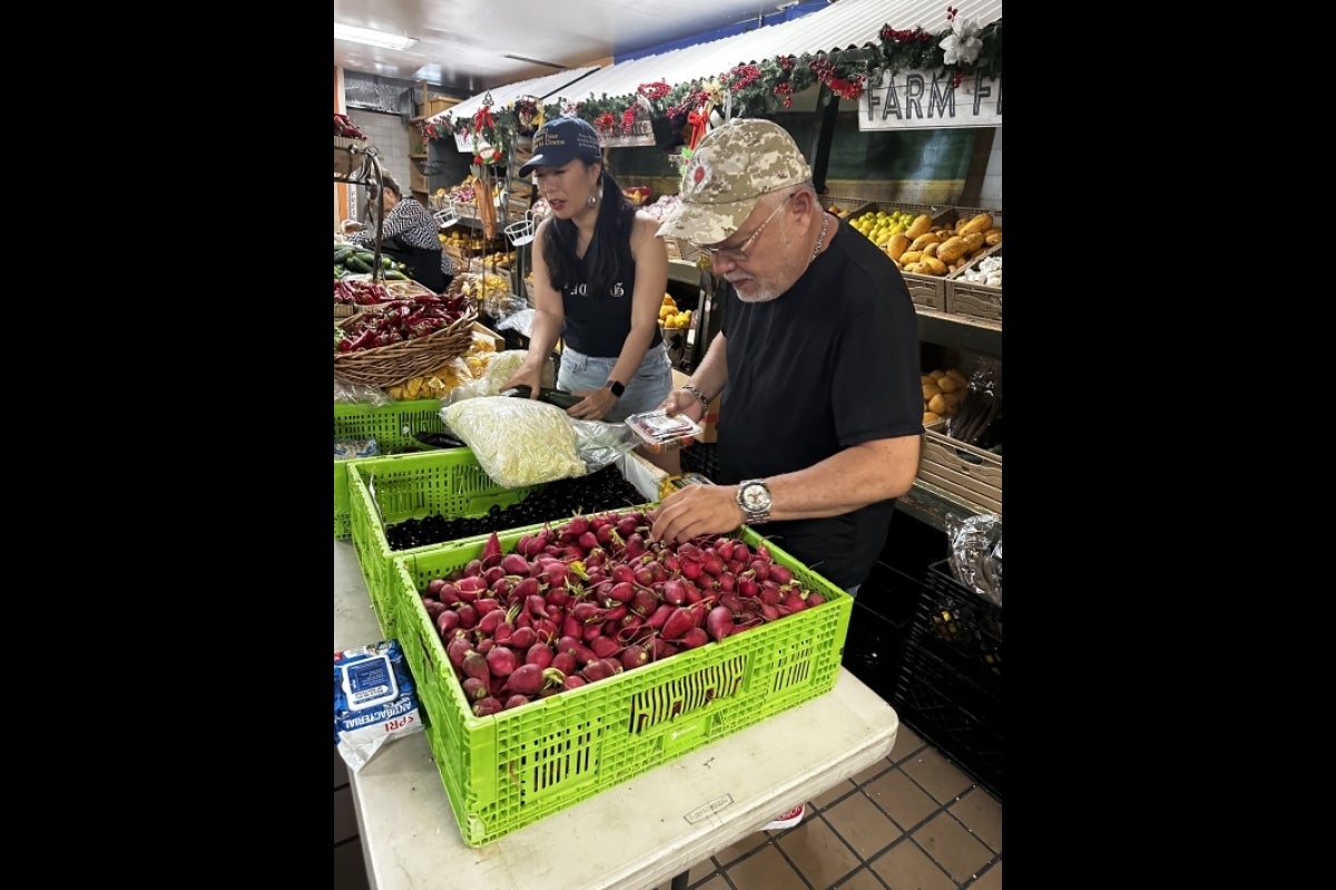 Workers preparing and arranging food at a food bank.