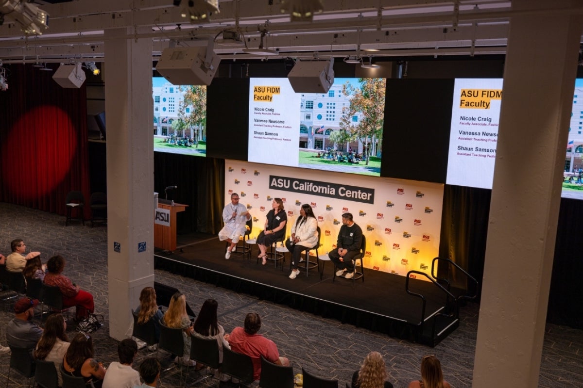 Four people on stage in a panel discussion