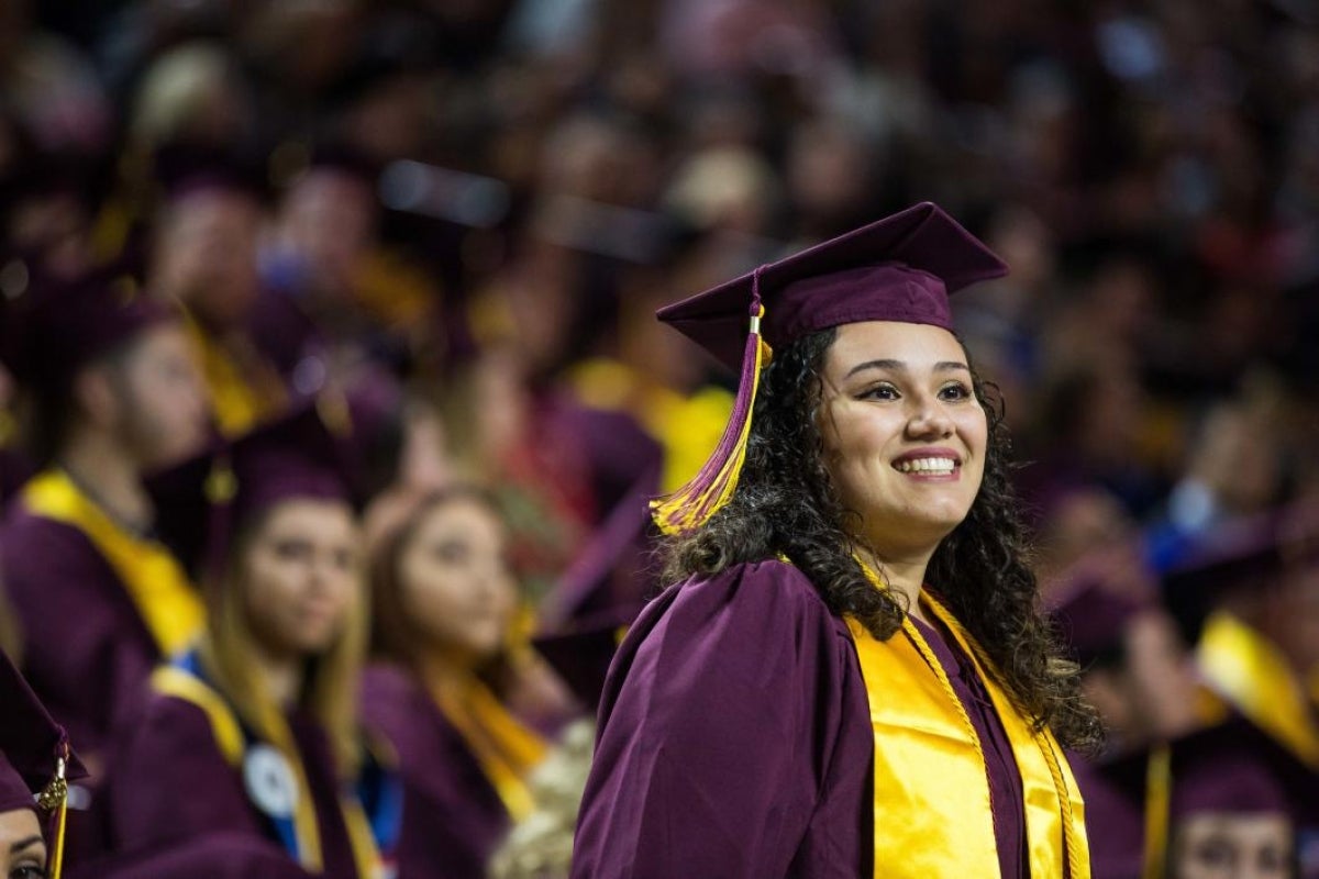 student standing at graduation