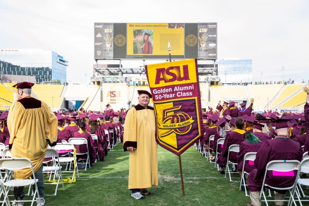 Gonfalon holder Ronald Davini at the undergraduate commencement ceremony.