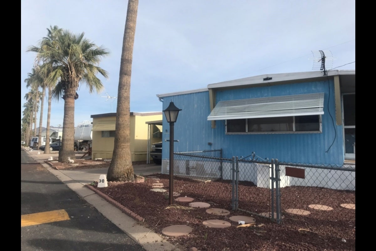 Street lined with mobile homes and palm trees